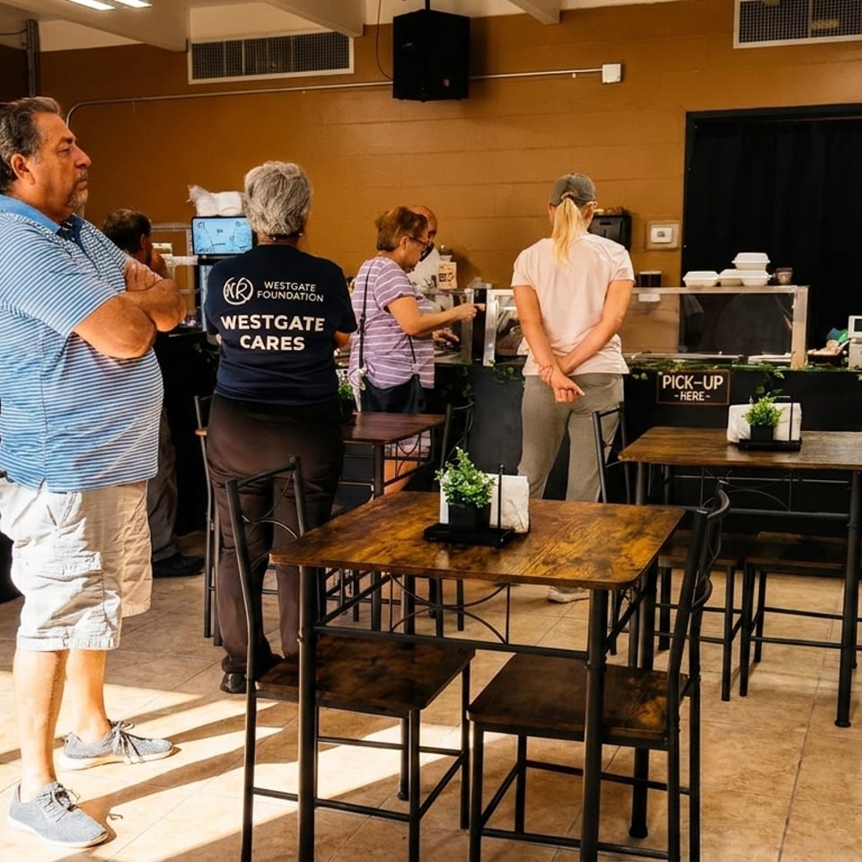 Customers wait in line at a restaurant counter with "Order Here" and "Pick-Up Here" signs.